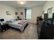 Cozy bedroom with a queen-size bed, TV, and carpeted floors at 4390 Bull St, St Cloud, FL 34772