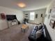 Bright bonus room with comfy seating and a workspace at 4390 Bull St, St Cloud, FL 34772