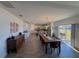 Open dining room with a long wooden table and view into kitchen at 4390 Bull St, St Cloud, FL 34772