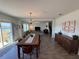 Bright dining room with a large wooden table and access to a patio at 4390 Bull St, St Cloud, FL 34772