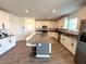 Modern kitchen with white cabinets, large island, and gray countertops at 4390 Bull St, St Cloud, FL 34772