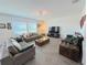 Spacious living room with comfy sofas, large TV, and wood-look flooring at 4390 Bull St, St Cloud, FL 34772