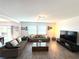 Living room with two sofas, coffee table, and a large TV at 4390 Bull St, St Cloud, FL 34772