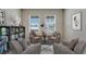 Cozy sitting area with armchairs, coffee table, and built-in bookcase at 4601 Boxwood Way, Mount Dora, FL 32757