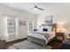 Bright bedroom with a queen bed, large windows, and dark wood floors at 4713 Anson Ln, Orlando, FL 32814