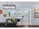 Open concept dining area with a view into the kitchen and living areas at 4713 Anson Ln, Orlando, FL 32814