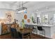 Bright dining room features a wood table, modern chandelier, and adjacent kitchen at 4713 Anson Ln, Orlando, FL 32814