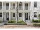 Front entrance of a townhouse with white columns and a black door at 4713 Anson Ln, Orlando, FL 32814