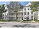 White townhouses with balconies, trees, and a street at 4713 Anson Ln, Orlando, FL 32814