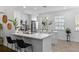 Modern white kitchen with stainless steel appliances and a large island at 4713 Anson Ln, Orlando, FL 32814