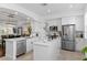 Modern white kitchen with stainless steel appliances and an island at 4713 Anson Ln, Orlando, FL 32814