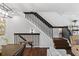 Modern staircase with dark wood railings leading to the upper level at 4713 Anson Ln, Orlando, FL 32814