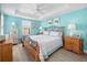Bright bedroom with a decorative metal bed frame, ceiling fan, and plenty of natural light at 5381 Via Appia Way, Sanford, FL 32771