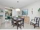 Inviting dining area with modern decor, sliding glass doors to the patio, and contemporary lighting at 5381 Via Appia Way, Sanford, FL 32771