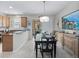 Dining area with stylish decor, a view of the kitchen, and access to the outdoor patio at 5381 Via Appia Way, Sanford, FL 32771