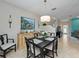 Open-concept dining area with stylish decor, a staircase, and a view into the living room at 5381 Via Appia Way, Sanford, FL 32771