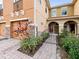 Inviting exterior showcasing a well-maintained townhome with a brick pathway and landscaped garden at 5381 Via Appia Way, Sanford, FL 32771
