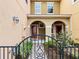 Welcoming entrance to a townhome with a gated walkway and a charming covered porch at 5381 Via Appia Way, Sanford, FL 32771