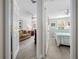 View of a living room and a bedroom with modern interiors through white doors at 5381 Via Appia Way, Sanford, FL 32771