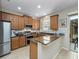 Well-equipped kitchen with stainless steel appliances, granite counters, and wood cabinetry at 5381 Via Appia Way, Sanford, FL 32771
