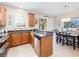 Open kitchen featuring stainless steel appliances, granite counters, and adjacent dining area at 5381 Via Appia Way, Sanford, FL 32771