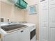 Convenient laundry room with modern appliances and ample storage at 5381 Via Appia Way, Sanford, FL 32771