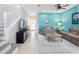 Cozy living room with a staircase, vibrant accent wall, and an open layout to the dining area at 5381 Via Appia Way, Sanford, FL 32771