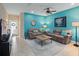 Modern living room featuring colorful walls, tile flooring, and comfortable furnishings at 5381 Via Appia Way, Sanford, FL 32771