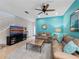 Open living room with a blue accent wall, neutral furniture, and a view of the staircase at 5381 Via Appia Way, Sanford, FL 32771