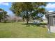 Lush backyard featuring a large shade tree and gazebo for outdoor relaxation at 608 S Oxalis Ave, Orlando, FL 32807