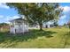 Spacious backyard featuring a gazebo and a large shade tree for outdoor enjoyment at 608 S Oxalis Ave, Orlando, FL 32807