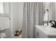 Stylish bathroom featuring tiled walls and shower with striped curtain at 608 S Oxalis Ave, Orlando, FL 32807