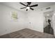 Bedroom with neutral carpeting, ceiling fan, and an open door to the hall at 608 S Oxalis Ave, Orlando, FL 32807