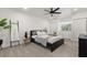 Inviting bedroom featuring a comfortable bed, plush carpeting, and bright natural lighting from a window at 608 S Oxalis Ave, Orlando, FL 32807
