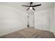 Bedroom with neutral carpeting, large closet, and open doorway to the hallway at 608 S Oxalis Ave, Orlando, FL 32807