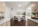 Cozy dining area adjacent to kitchen with white table, hardwood floors, and neutral decor at 608 S Oxalis Ave, Orlando, FL 32807