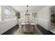 Bright dining room featuring a white table with seating for six, hardwood floors, and natural light at 608 S Oxalis Ave, Orlando, FL 32807