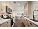 Bright kitchen with updated stainless steel appliances, sleek countertops and stylish hardwood flooring at 608 S Oxalis Ave, Orlando, FL 32807