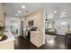 Open kitchen layout leading to living area with stainless steel appliances, granite countertops and recessed lighting at 608 S Oxalis Ave, Orlando, FL 32807