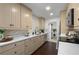 Well-lit kitchen featuring modern countertops, cabinetry, backsplash and a stainless steel dishwasher at 608 S Oxalis Ave, Orlando, FL 32807