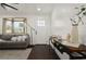Bright living room features a bay window with a view, modern decor, and plenty of natural light at 608 S Oxalis Ave, Orlando, FL 32807