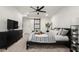 Cozy main bedroom features a ceiling fan, neutral decor, and an ensuite bathroom with a sliding barn door at 608 S Oxalis Ave, Orlando, FL 32807