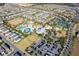 An aerial view of a community highlighting the water park, pools, clubhouse, and tennis courts at 7600 Mackinaw Ln, Kissimmee, FL 34747