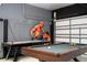 Basement with pool table, air hockey table and mural at 7600 Mackinaw Ln, Kissimmee, FL 34747