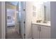 Well-lit bathroom with a neutral color palette featuring an open doorway leading into the Primary bedroom at 7600 Mackinaw Ln, Kissimmee, FL 34747