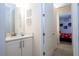 Bright bathroom featuring a single sink, quartz counters, and decorative wall art at 7600 Mackinaw Ln, Kissimmee, FL 34747