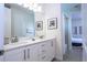 Bright bathroom featuring dual sinks, quartz counters, and access to shower/tub combo at 7600 Mackinaw Ln, Kissimmee, FL 34747