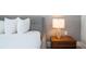 Close-up of a bedroom with a lamp on a bedside table at 7600 Mackinaw Ln, Kissimmee, FL 34747