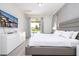 Modern bedroom featuring a grey platform bed, pool view, TV, and access to an outdoor pool area at 7600 Mackinaw Ln, Kissimmee, FL 34747