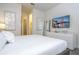 Cozy bedroom with a white dresser and a wall-mounted TV at 7600 Mackinaw Ln, Kissimmee, FL 34747